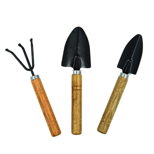 A set of three indoor gardening tools set with wooden handles: a trowel, a cultivator, and a smaller trowel.